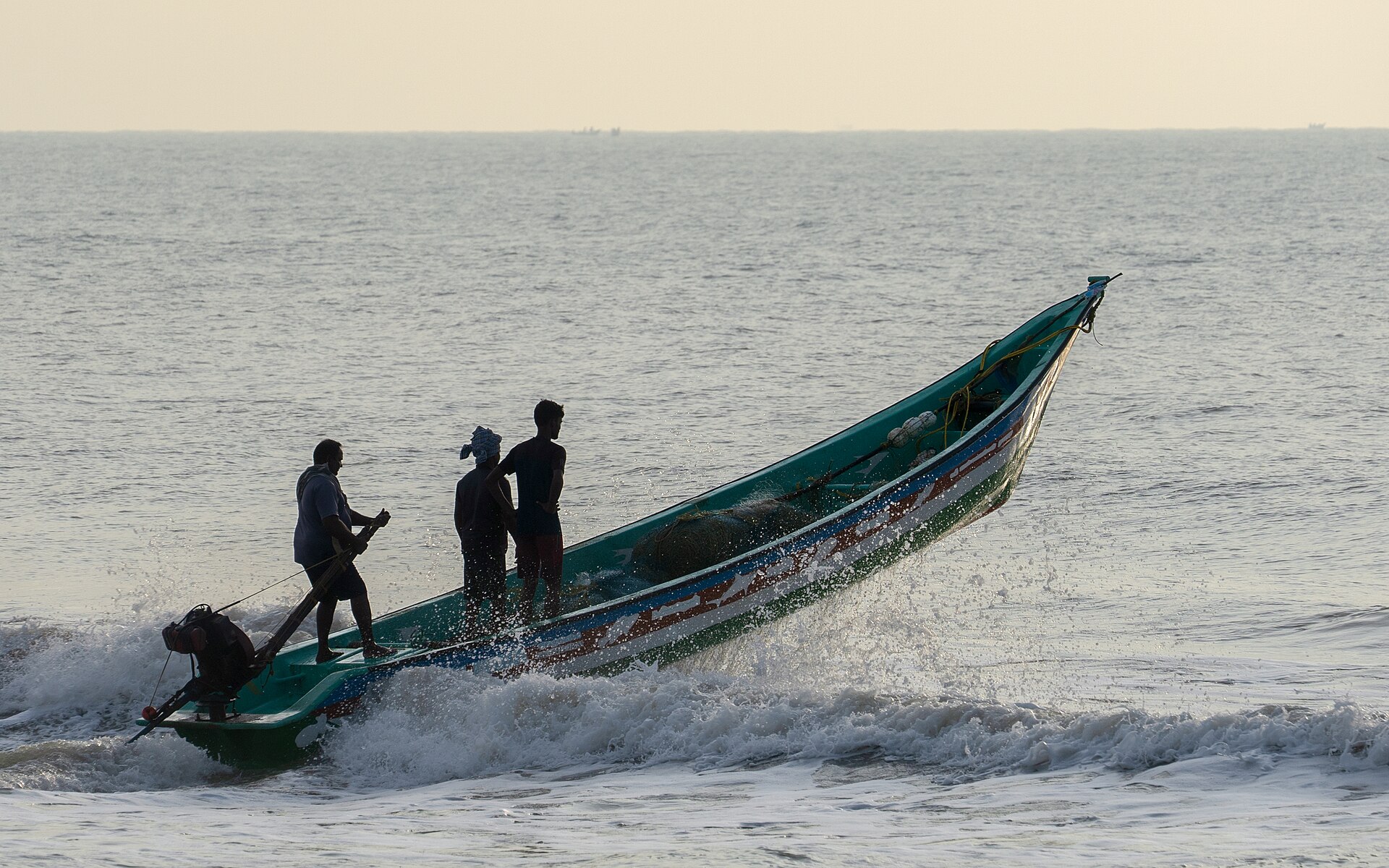 A fishing boat riding waves near Mahabalipuram
